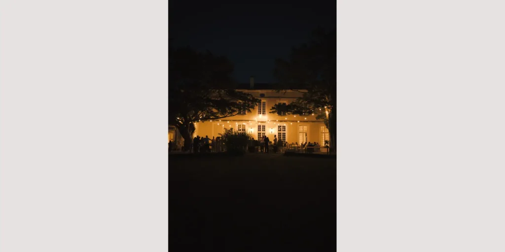 Fairy lights illuminating a late-night wedding reception under the stars in a French private estate.